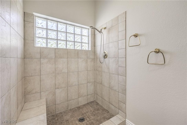 full bath featuring a tile shower