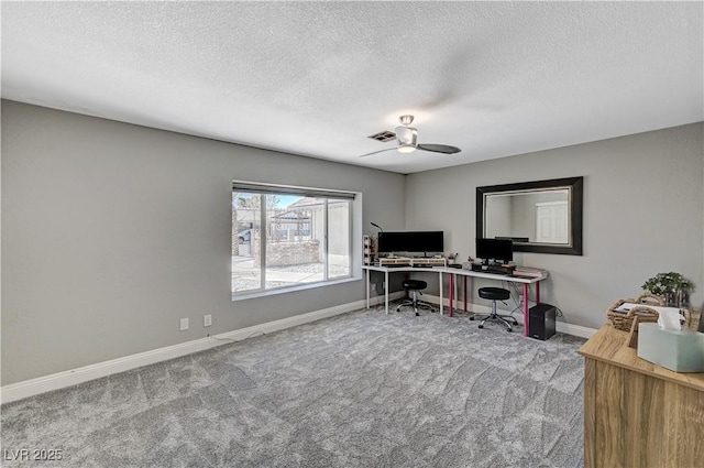 carpeted home office with baseboards, a ceiling fan, and a textured ceiling