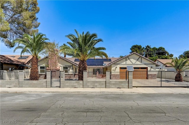view of front facade featuring a gate, a fenced front yard, stucco siding, and solar panels