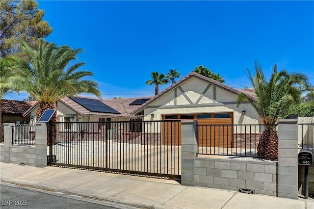 view of front facade with a fenced front yard, a tile roof, and stucco siding