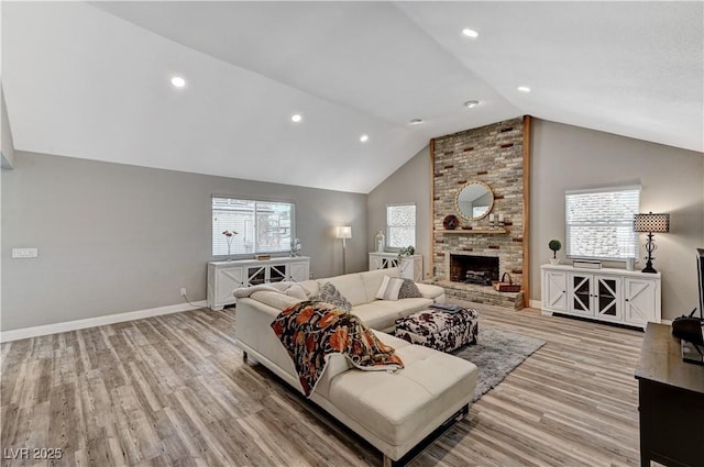 living area featuring baseboards, recessed lighting, light wood finished floors, and a brick fireplace