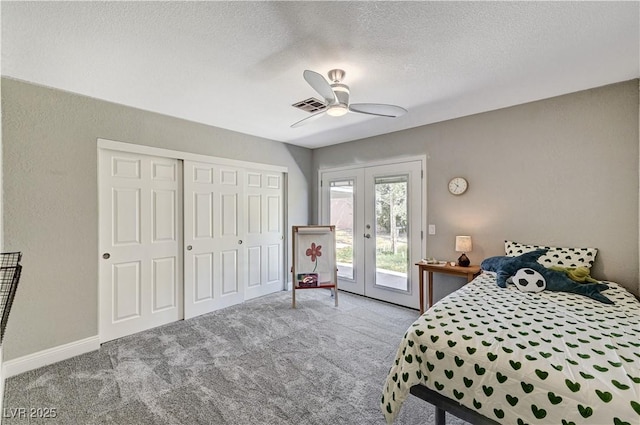 bedroom featuring french doors, a textured ceiling, visible vents, access to exterior, and carpet floors