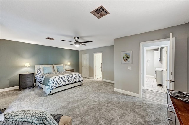 carpeted bedroom with a ceiling fan, baseboards, and visible vents