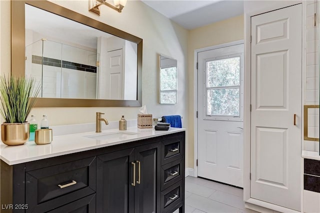 full bathroom featuring vanity, tile patterned flooring, and a shower stall
