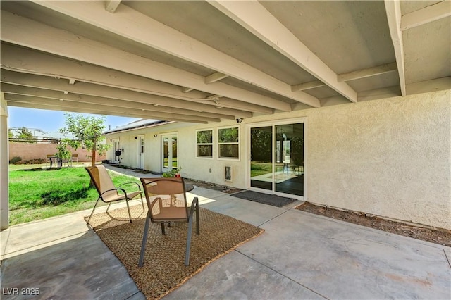 view of patio featuring fence and french doors