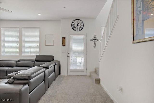 664 Foam Flower Ln, Henderson, NV 89015 - carpeted living area featuring stairs, baseboards, and ceiling fan