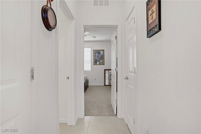 664 Foam Flower Ln, Henderson, NV 89015 - hallway featuring light carpet, baseboards, and light tile patterned floors