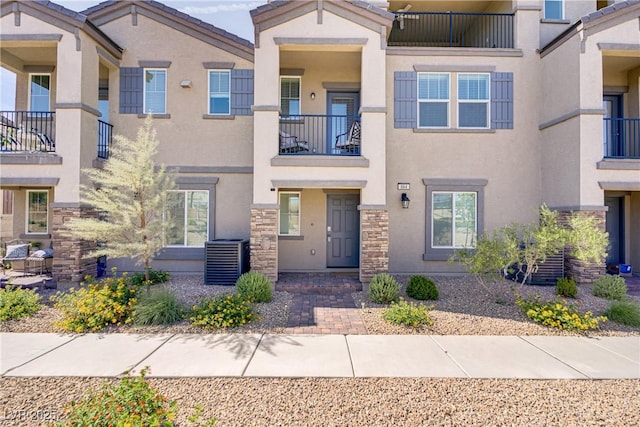 664 Foam Flower Ln, Henderson, NV 89015 - townhome / multi-family property with stucco siding, central AC unit, and stone siding