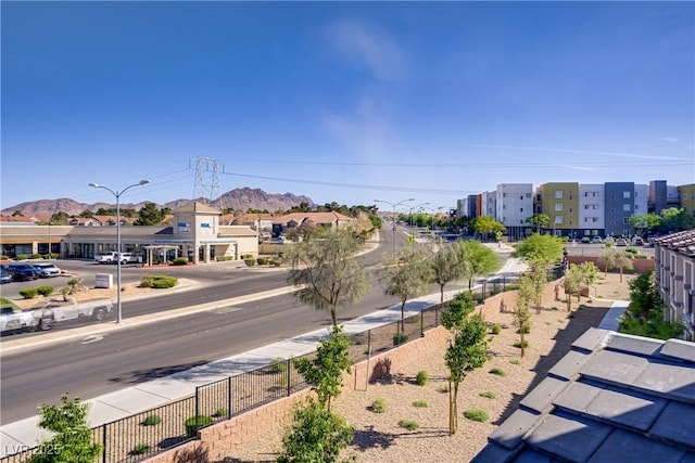 664 Foam Flower Ln, Henderson, NV 89015 - view of asphalt road with sidewalks, street lighting, and a mountain view