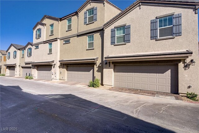 664 Foam Flower Ln, Henderson, NV 89015 - townhome / multi-family property featuring a garage, stucco siding, and a residential view