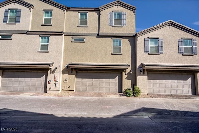 664 Foam Flower Ln, Henderson, NV 89015 - townhome / multi-family property featuring a garage, stucco siding, and a tile roof