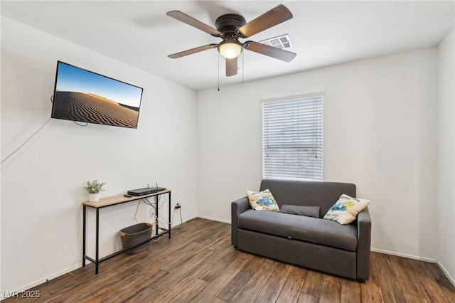 living area with a ceiling fan, baseboards, visible vents, and wood finished floors