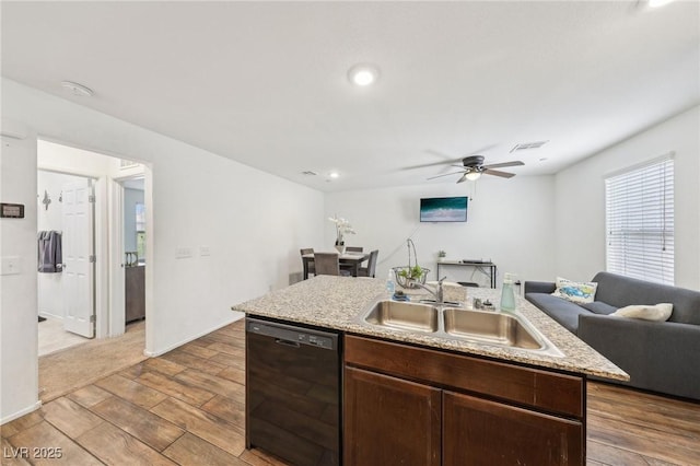 kitchen featuring a ceiling fan, wood finished floors, open floor plan, black dishwasher, and a sink