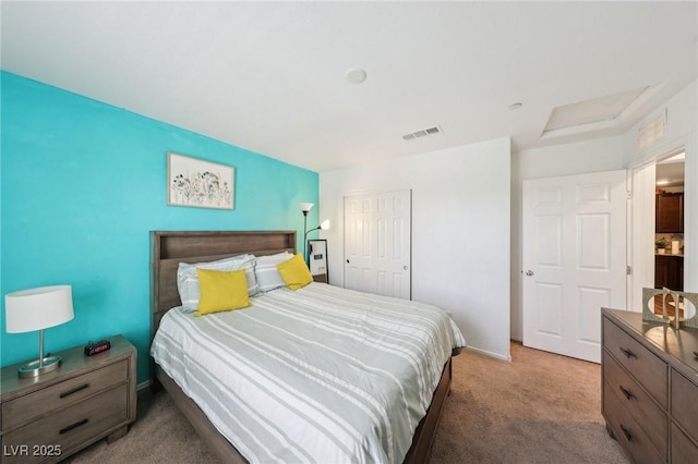 carpeted bedroom with baseboards, a closet, and visible vents