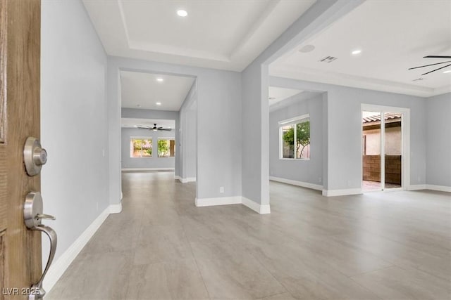 entrance foyer featuring a wealth of natural light, a ceiling fan, and visible vents
