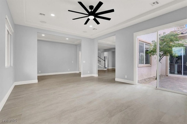unfurnished living room with stairs, baseboards, and visible vents