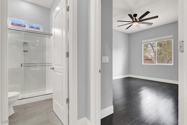 interior space featuring baseboards and wood finished floors