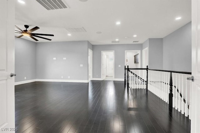 spare room with dark wood-style flooring, ceiling fan, recessed lighting, baseboards, and visible vents