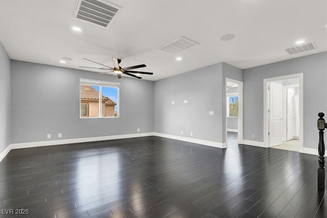 spare room featuring visible vents, ceiling fan, and a wealth of natural light