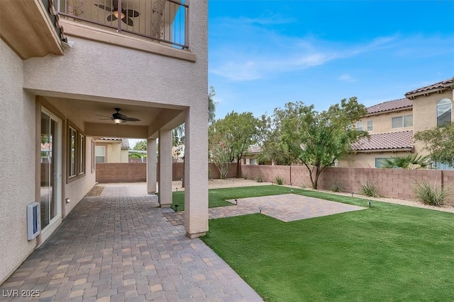 view of yard featuring a patio, a ceiling fan, and a fenced backyard