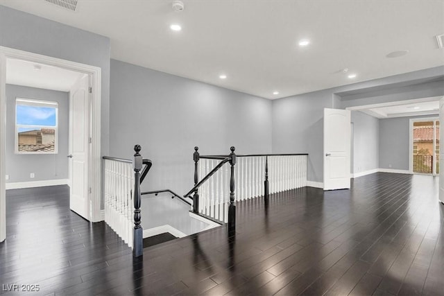 interior space featuring recessed lighting, baseboards, and wood finished floors