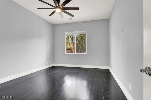 empty room featuring ceiling fan, visible vents, baseboards, and dark wood finished floors