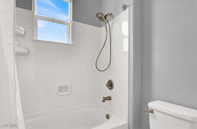 bathroom featuring toilet and shower / tub combo with curtain