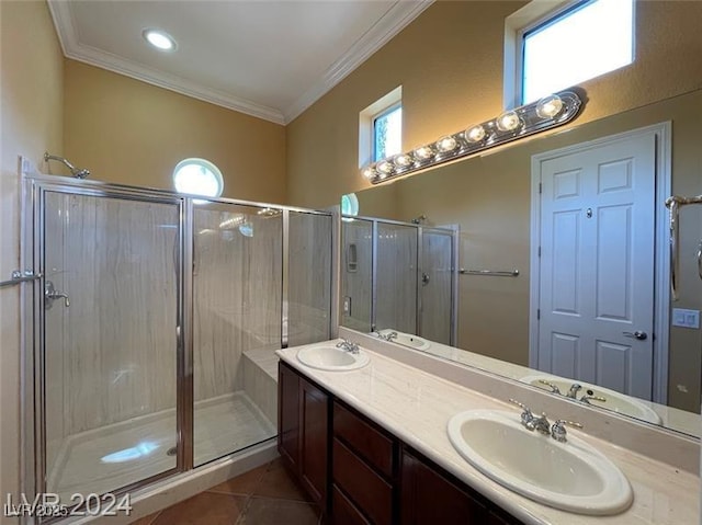 full bathroom with a sink, tile patterned flooring, a shower stall, and crown molding