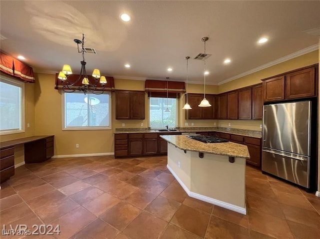 kitchen with crown molding, freestanding refrigerator, light stone countertops, baseboards, and gas stovetop