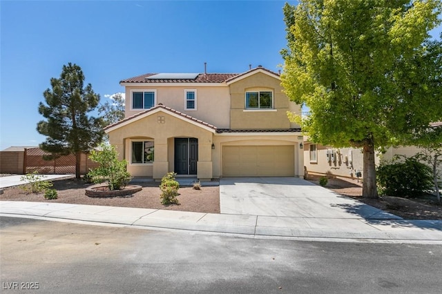 view of front of property featuring driveway, solar panels, a tile roof, an attached garage, and stucco siding