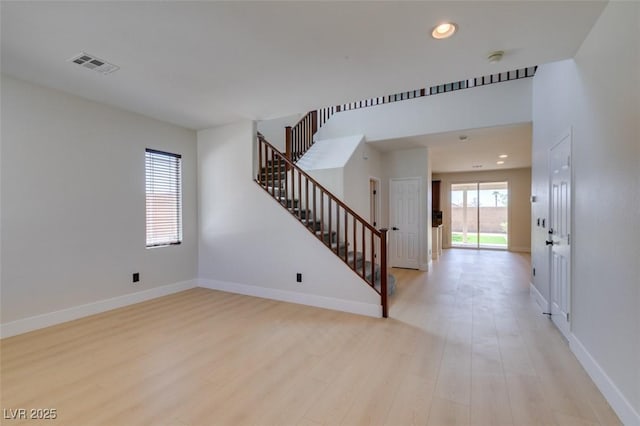 interior space with visible vents, stairs, baseboards, light wood-style floors, and recessed lighting