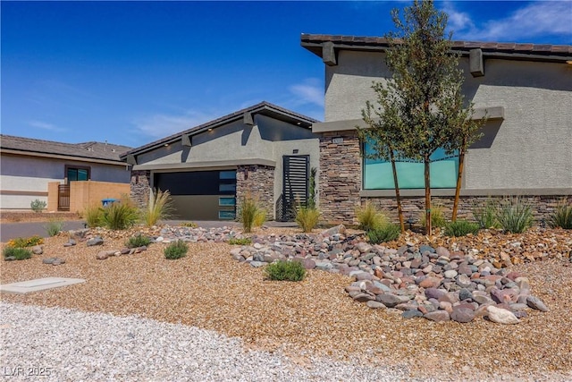8310 W Camero Ave, Las Vegas, NV 89113 - prairie-style house with stucco siding, an attached garage, and stone siding