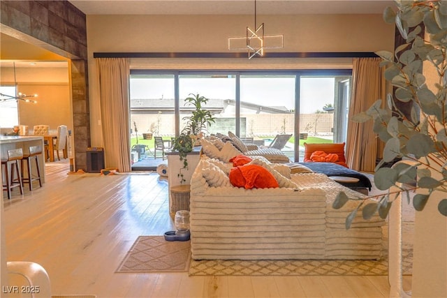 8310 W Camero Ave, Las Vegas, NV 89113 - living area with an inviting chandelier, plenty of natural light, and hardwood / wood-style flooring