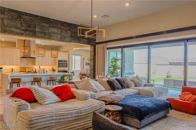 8310 W Camero Ave, Las Vegas, NV 89113 - living room with a high ceiling, recessed lighting, a chandelier, and visible vents