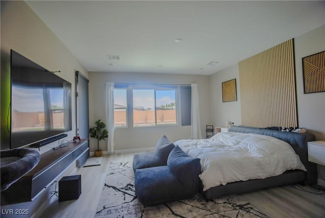 8310 W Camero Ave, Las Vegas, NV 89113 - bedroom with baseboards, wood finished floors, and visible vents