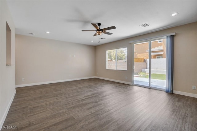 unfurnished room featuring ceiling fan, dark wood finished floors, recessed lighting, baseboards, and visible vents