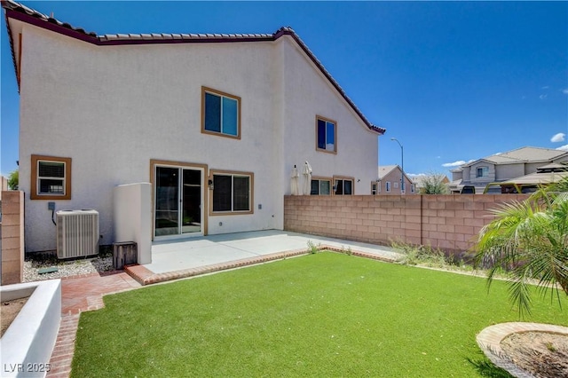 rear view of house featuring a patio, fence, central AC unit, and stucco siding