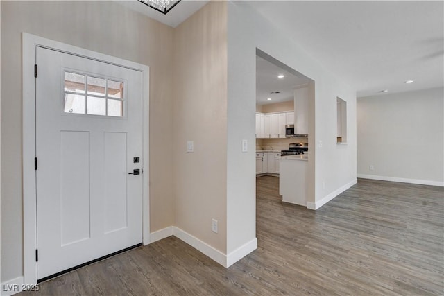 entryway featuring recessed lighting, baseboards, and wood finished floors