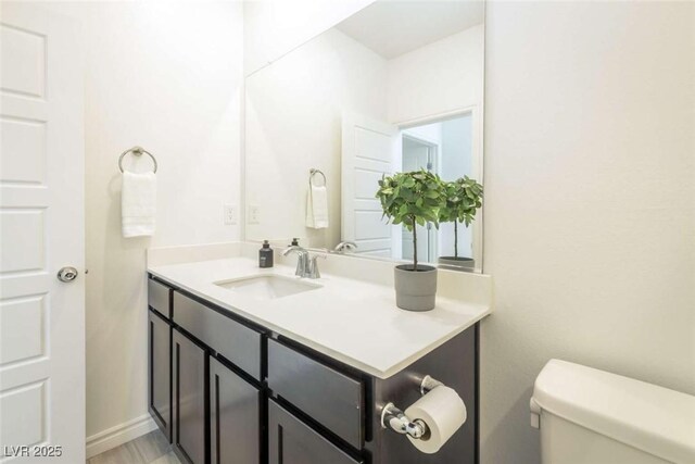 bathroom featuring toilet and vanity