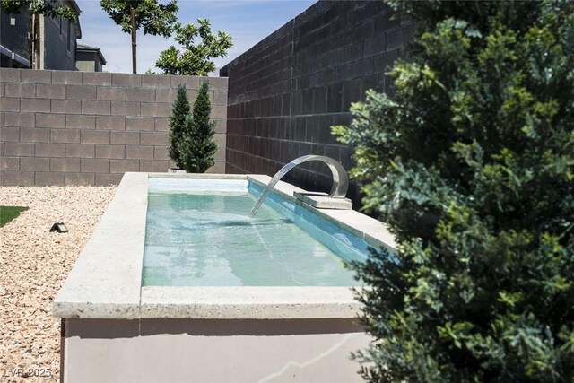 view of pool featuring fence