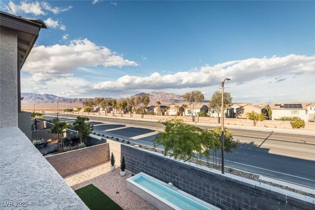 balcony with a residential view and a mountain view