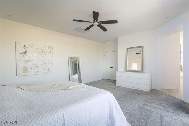 carpeted bedroom with visible vents and a ceiling fan