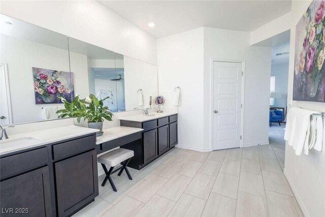 bathroom featuring vanity, recessed lighting, and baseboards