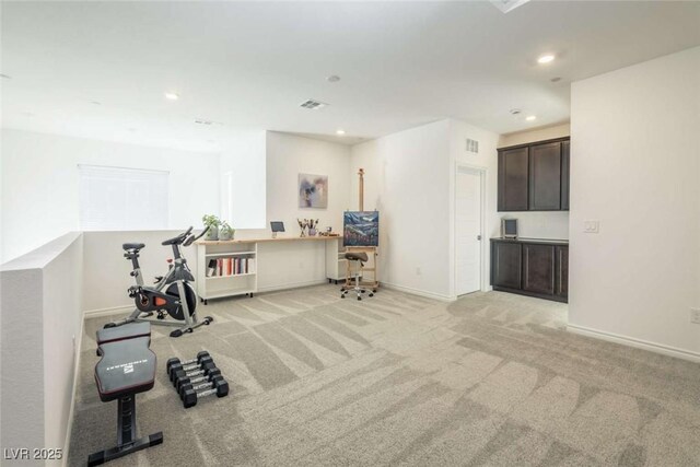 exercise room featuring recessed lighting, baseboards, visible vents, and light carpet