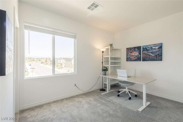 carpeted office with visible vents and baseboards