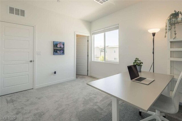 carpeted office space featuring visible vents and baseboards