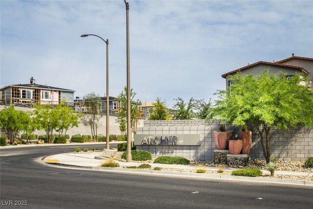 view of street with sidewalks, curbs, and street lights
