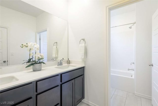 9732 Abel Cliff St, Las Vegas, NV 89143 - bathroom featuring double vanity,  shower combination, and baseboards