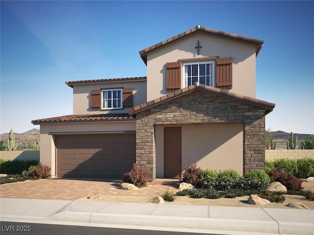 mediterranean / spanish-style home with stone siding, decorative driveway, stucco siding, a tiled roof, and an attached garage