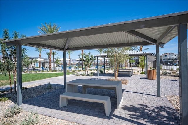 view of community featuring fence and a gazebo